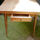 wooden dining table with compass legs and extensions