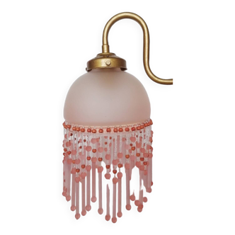 Pink glass wall lamp with garland of pearls