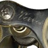 Old brass binoculars with integrated compass