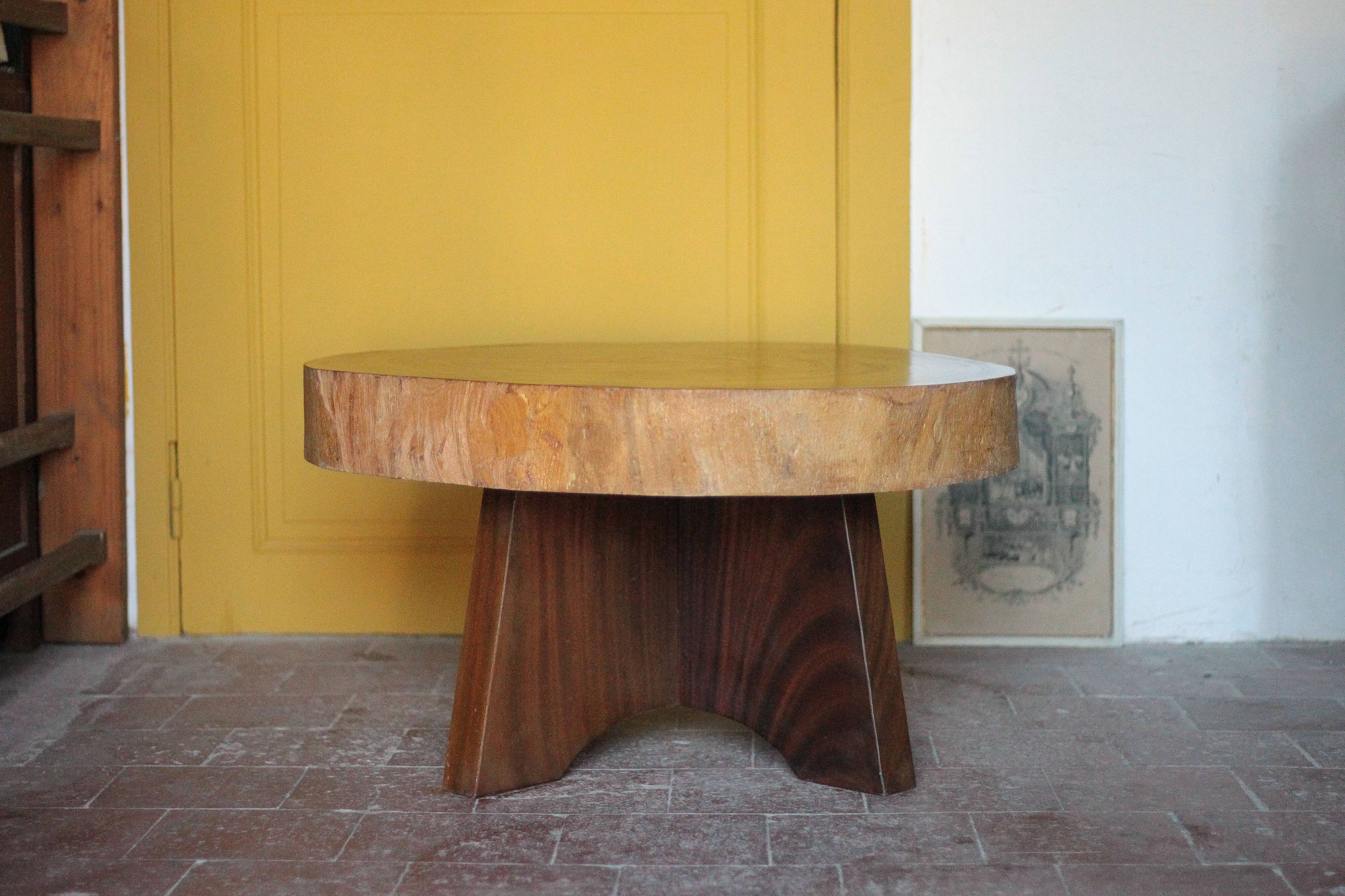 Brutalist wooden coffee table, cruciform leg with a tree trunk top.