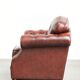 Cowhide chesterfield armchair in a warm brown colour with decorative nails