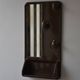 Wall mirror in moulded plastic with hooks and shelf.