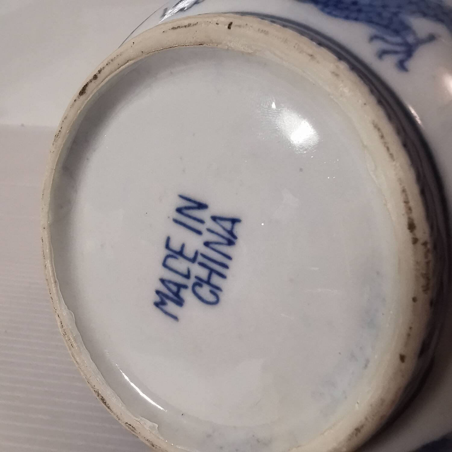 Old Chinese blue and white teapot in vintage ceramic with dragon decor