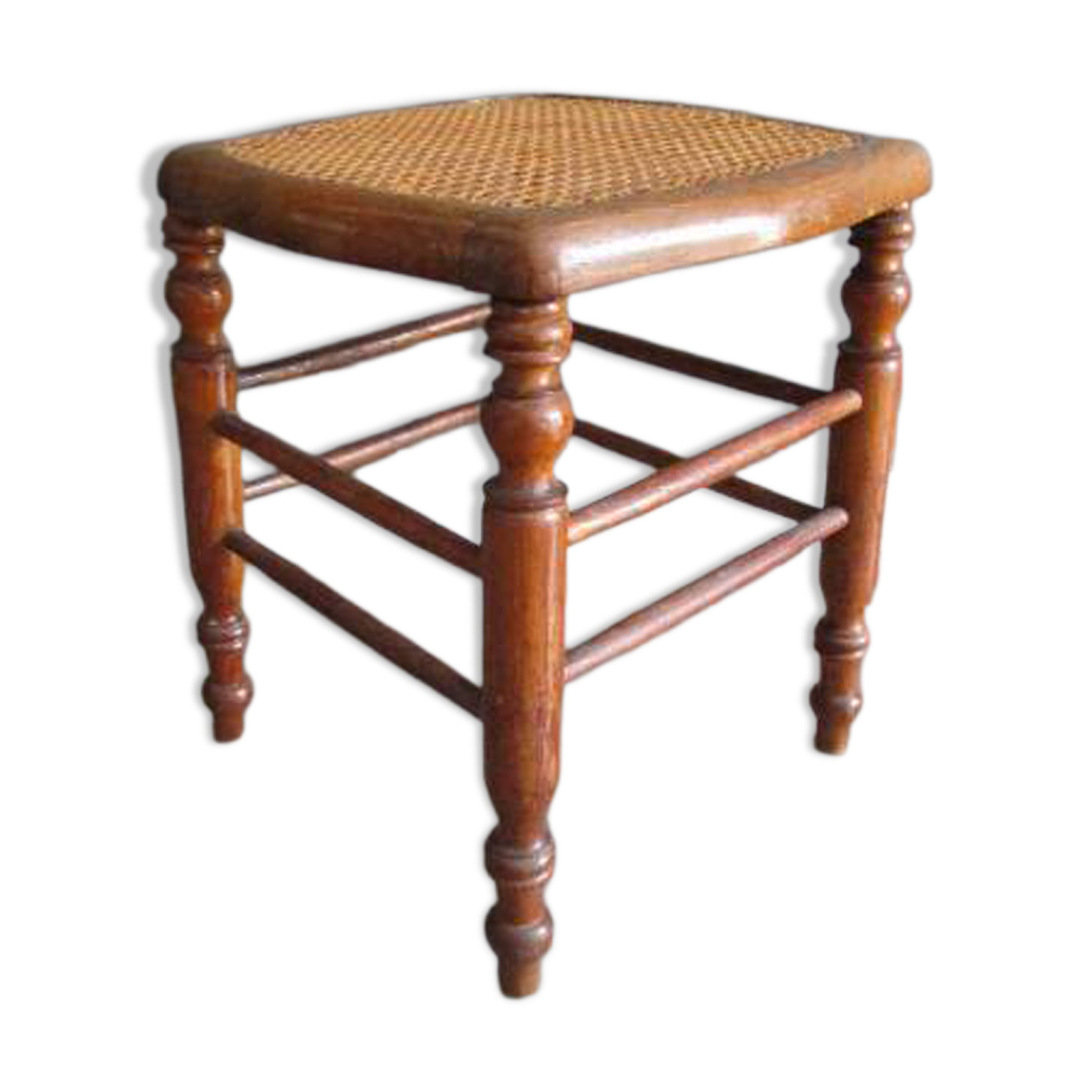 Antique wooden stool with cane seat.
