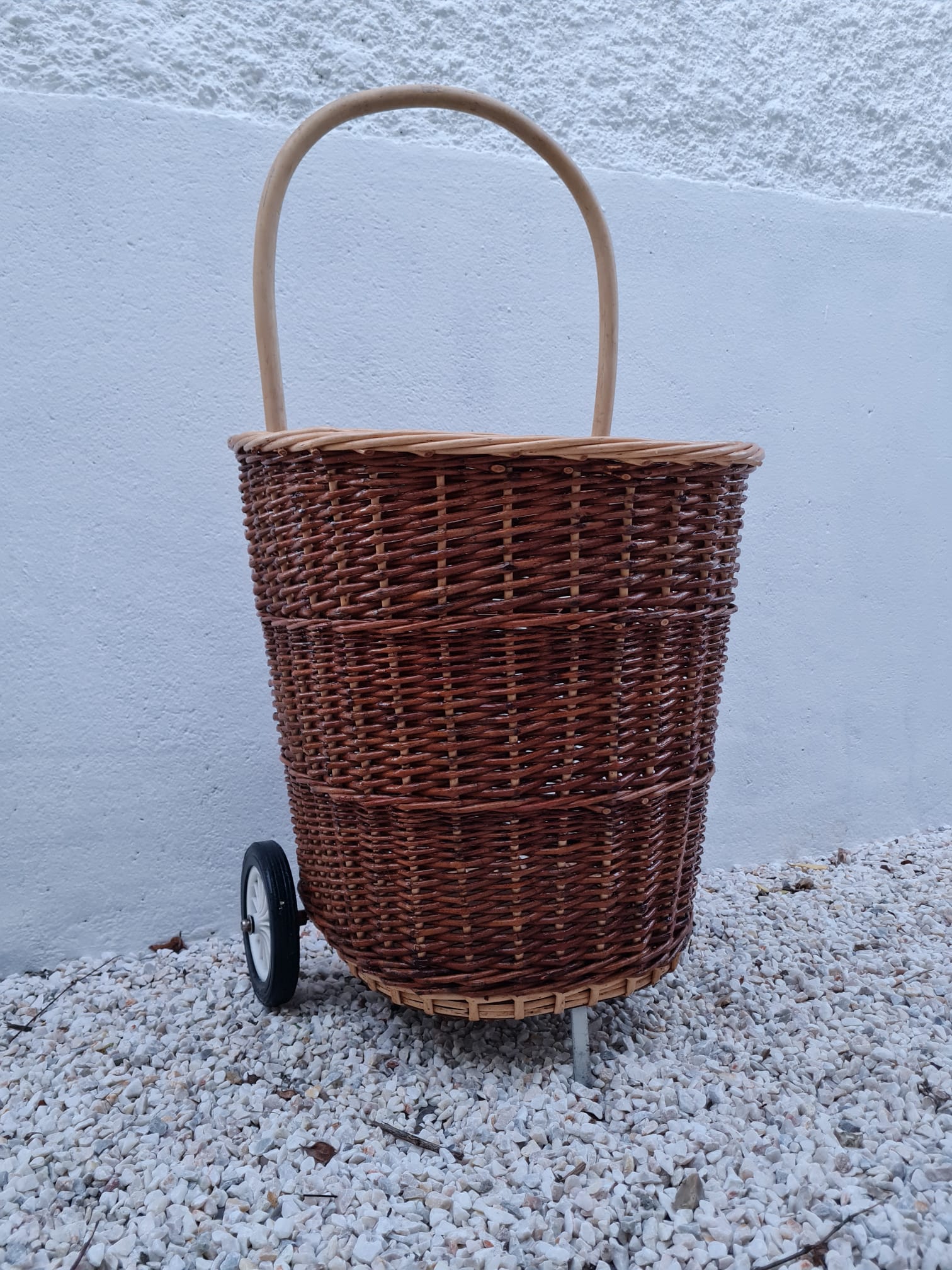 Vintage wicker log basket on vintage wheels