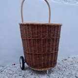 Vintage wicker log basket on vintage wheels