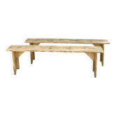 Pair of old farmhouse benches made of raw solid wood.