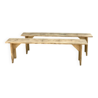 Pair of old farmhouse benches made of raw solid wood.