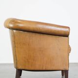Comfortable, cozy, warm colored sheepskin club chair finished with decorative nails