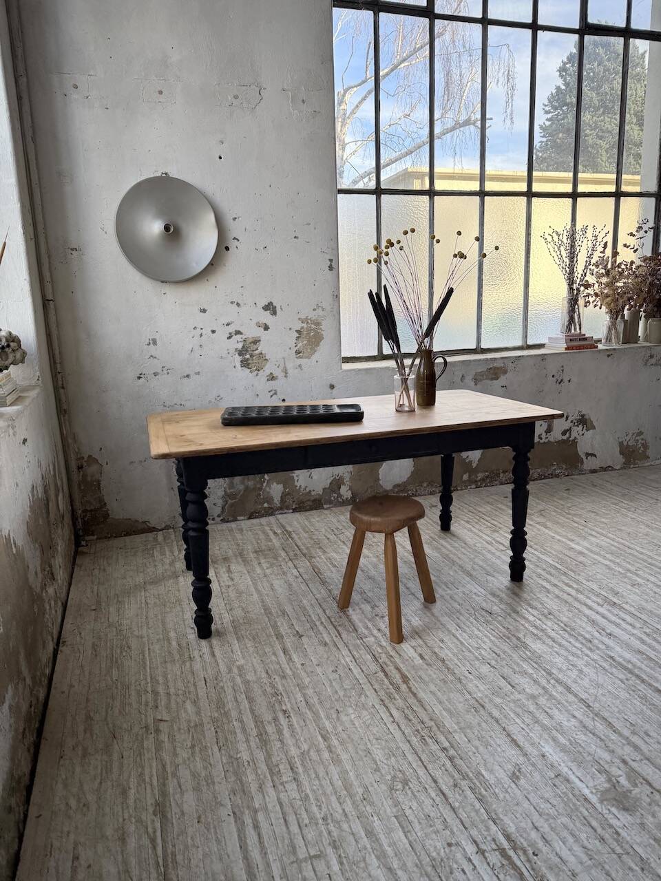 Oak farmhouse table with turned black legs.