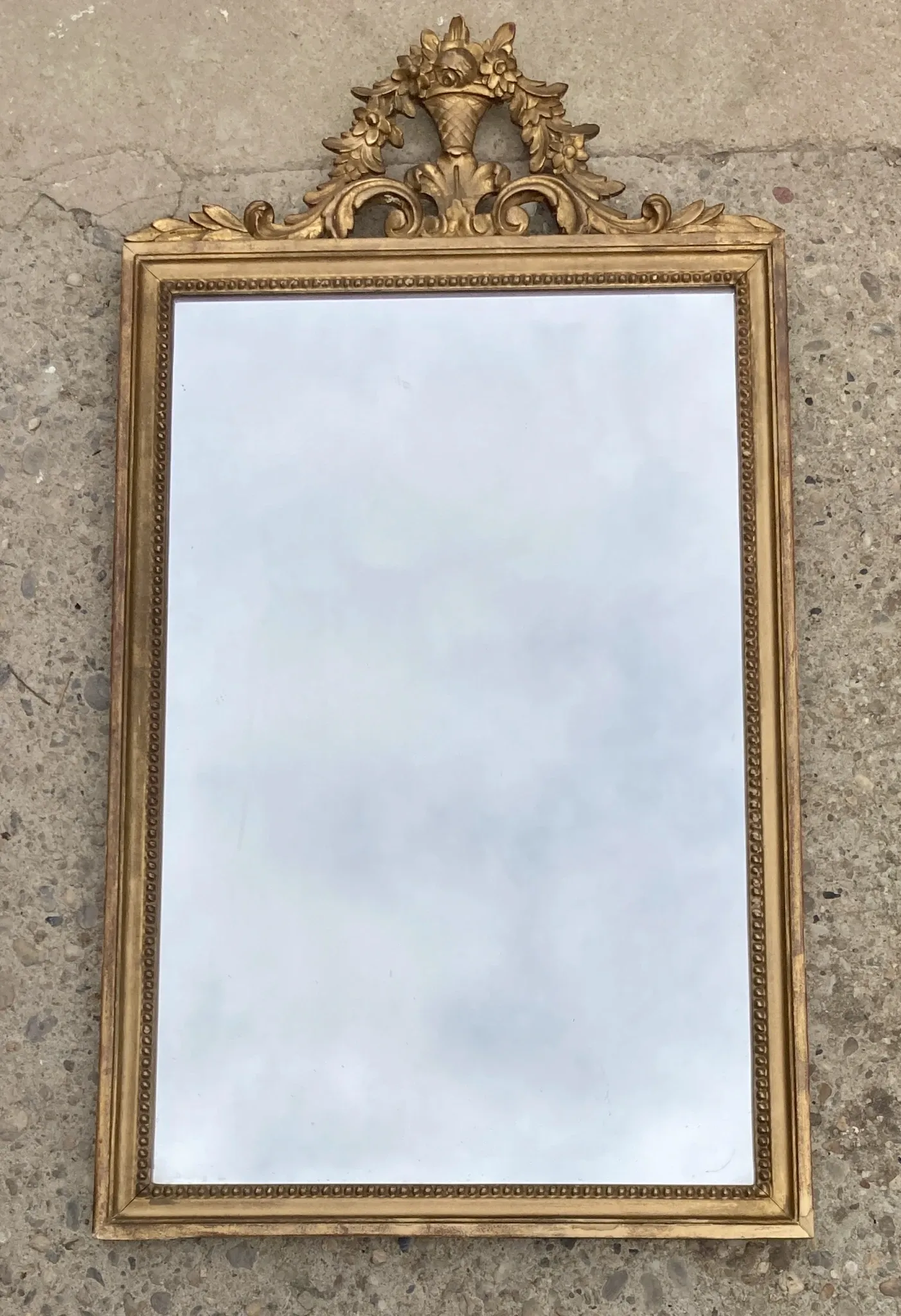 Antique mirror in wood and gilded stucco with a pediment - in the style of the 18th century.