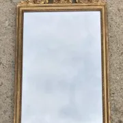 Antique mirror in wood and gilded stucco with a pediment - in the style of the 18th century.