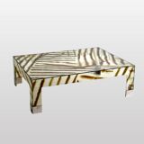 A zebra-striped plexiglass coffee table