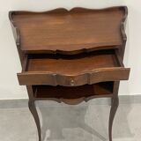Stylized bedside table with curved shapes