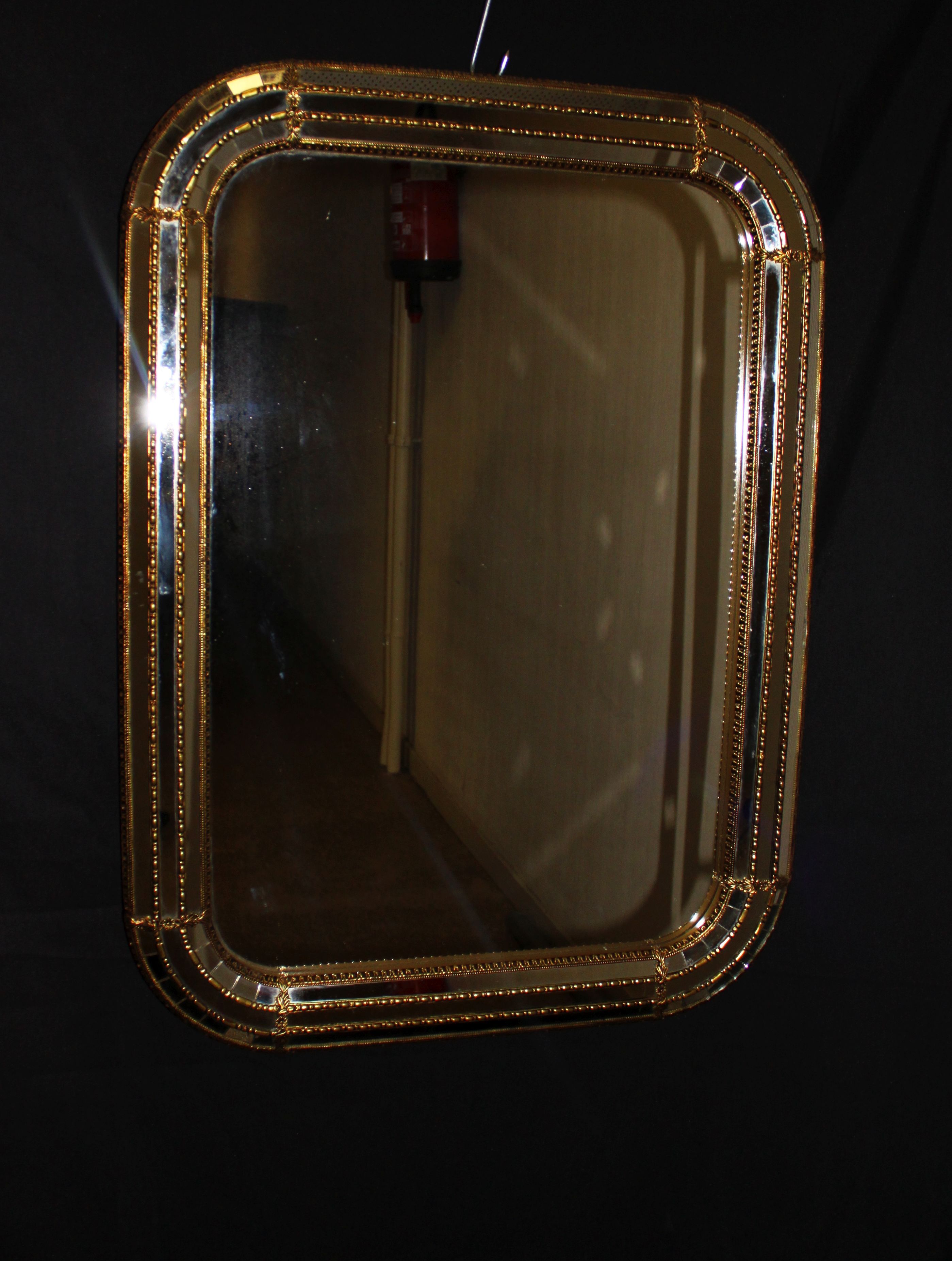 Faceted mirror and gold brass pare closes
