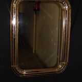 Faceted mirror and gold brass pare closes