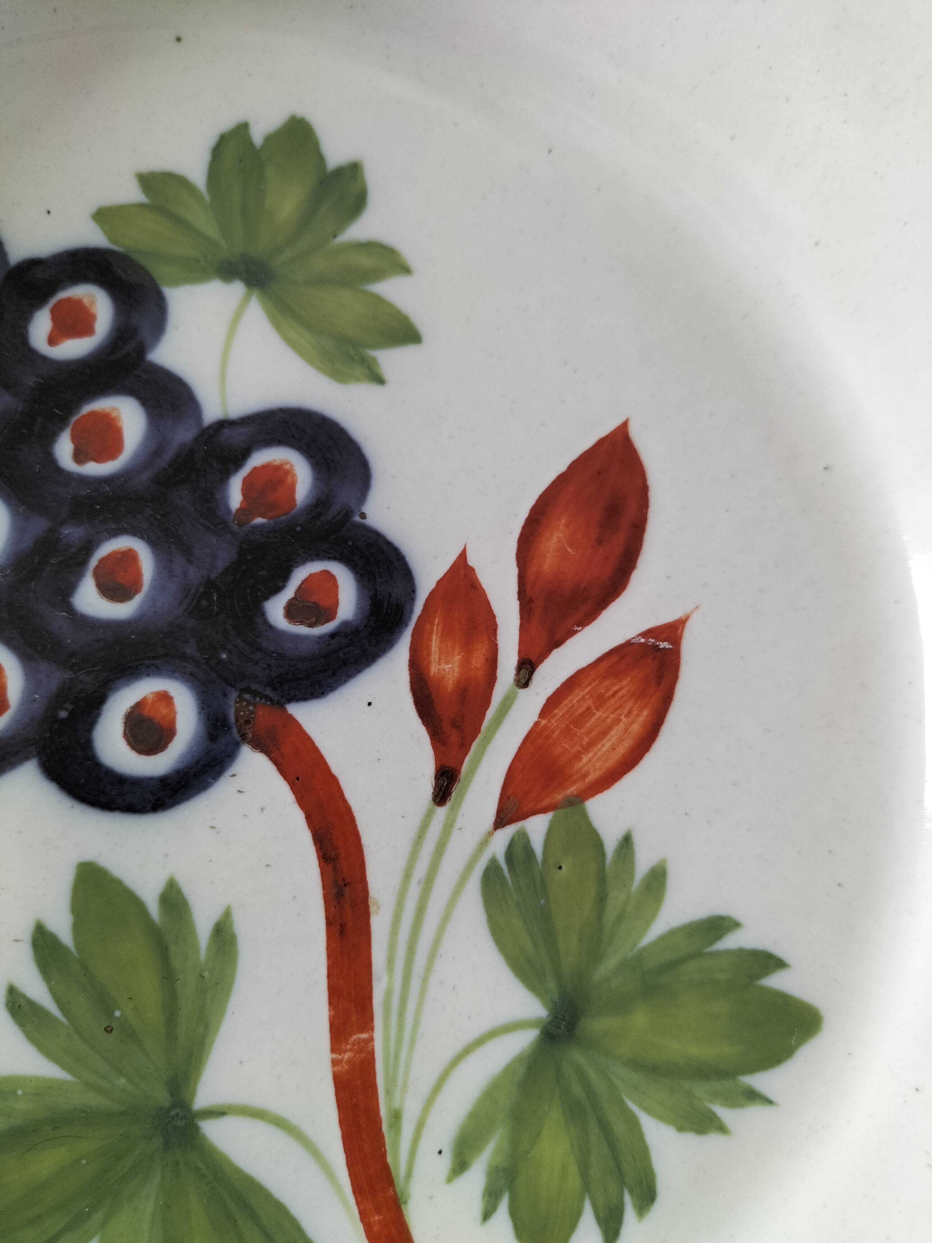 Pair of antique soup plates with hand-painted grape decoration