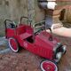 Old pedal car in tole fire truck