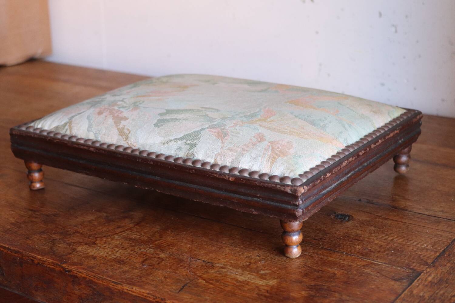 Small antique wooden and fabric footrest.