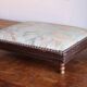 Small antique wooden and fabric footrest.