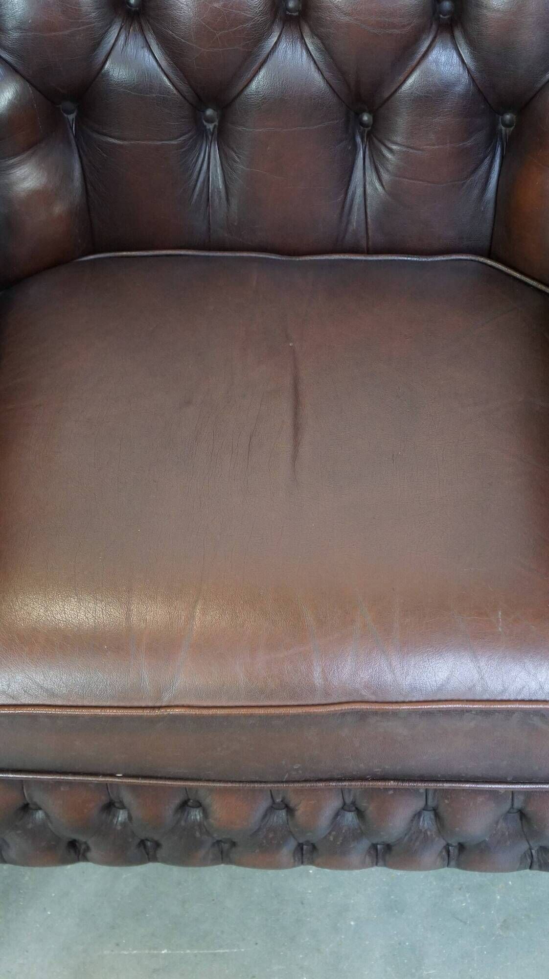 Beautiful and spacious dark brown mottled English cow leather Chesterfield armchair