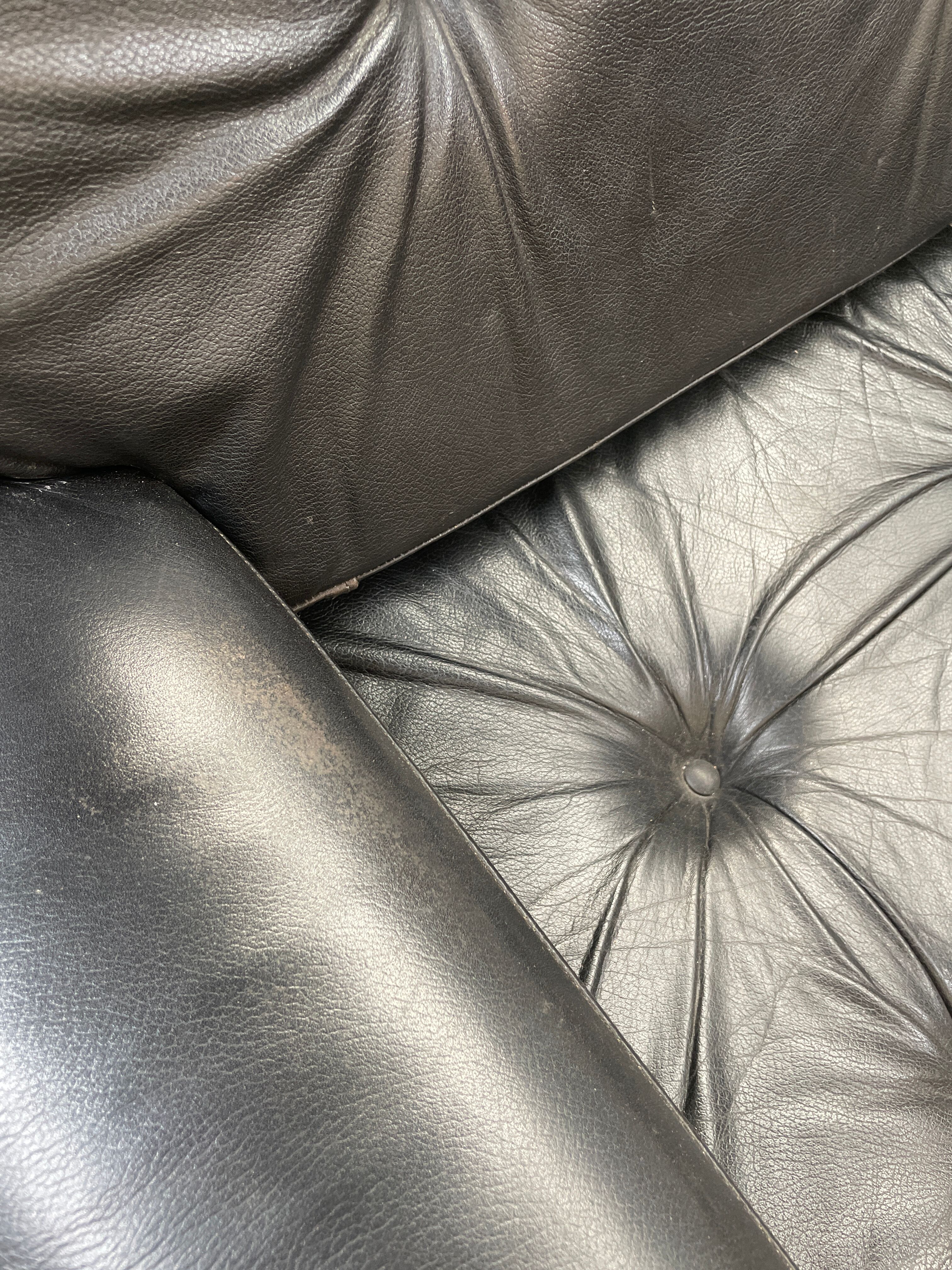Pair of black leather armchairs