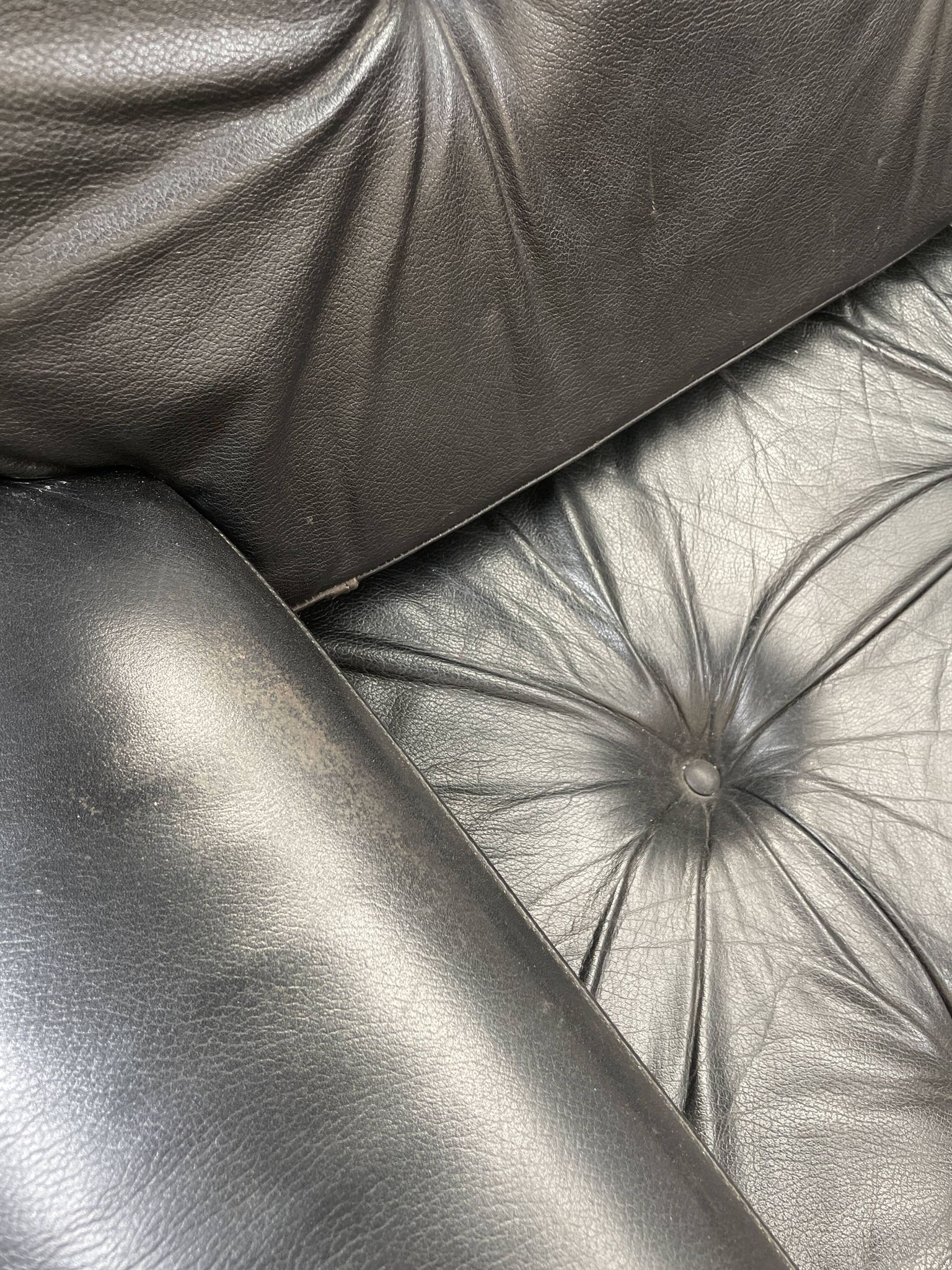 Pair of black leather armchairs