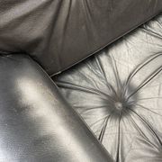 Pair of black leather armchairs
