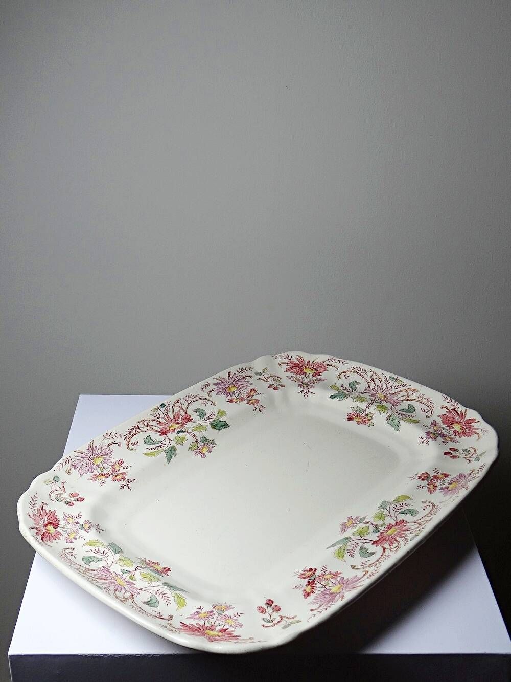 Antique Longchamp serving platter with polychrome daisies in ironstone.