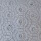 White bed throw with relief embroidery and floral patterns