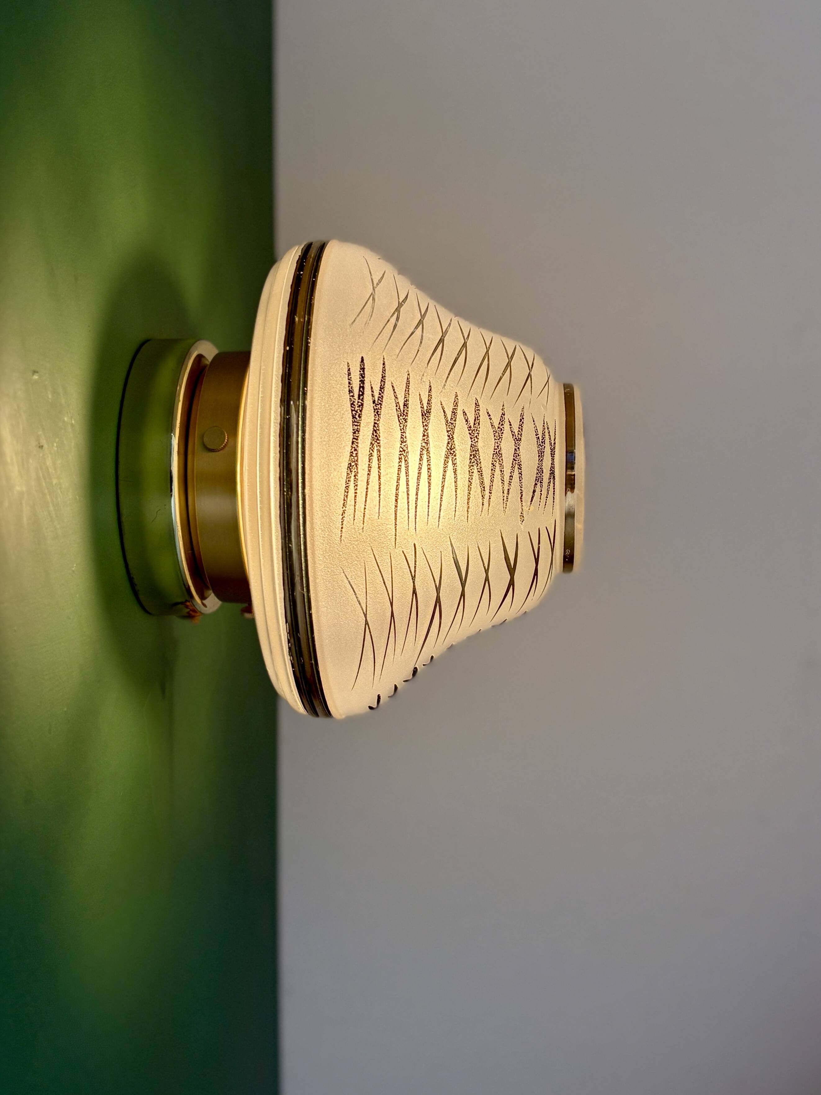 Vintage Art Deco globe wall/ceiling light in white, black, and gold glass.