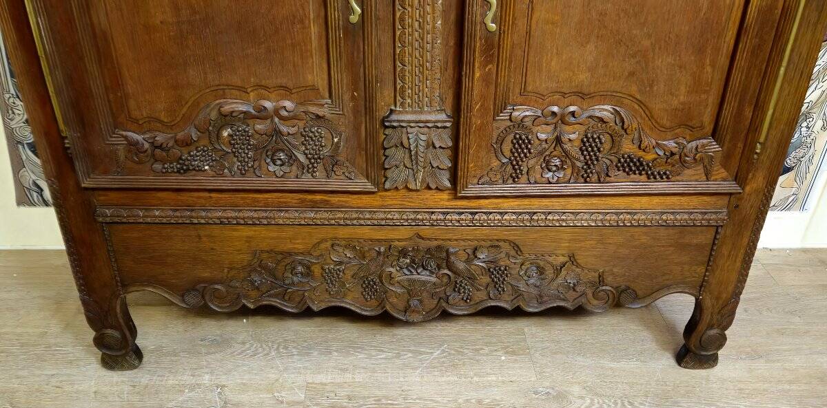 Norman Wedding Armoire in solid oak, richly carved, Louis period.
