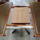 Round Regency dining table in mahogany and green leather with extensions - 20th century