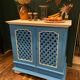 Large colonial style wooden cabinet with latticework