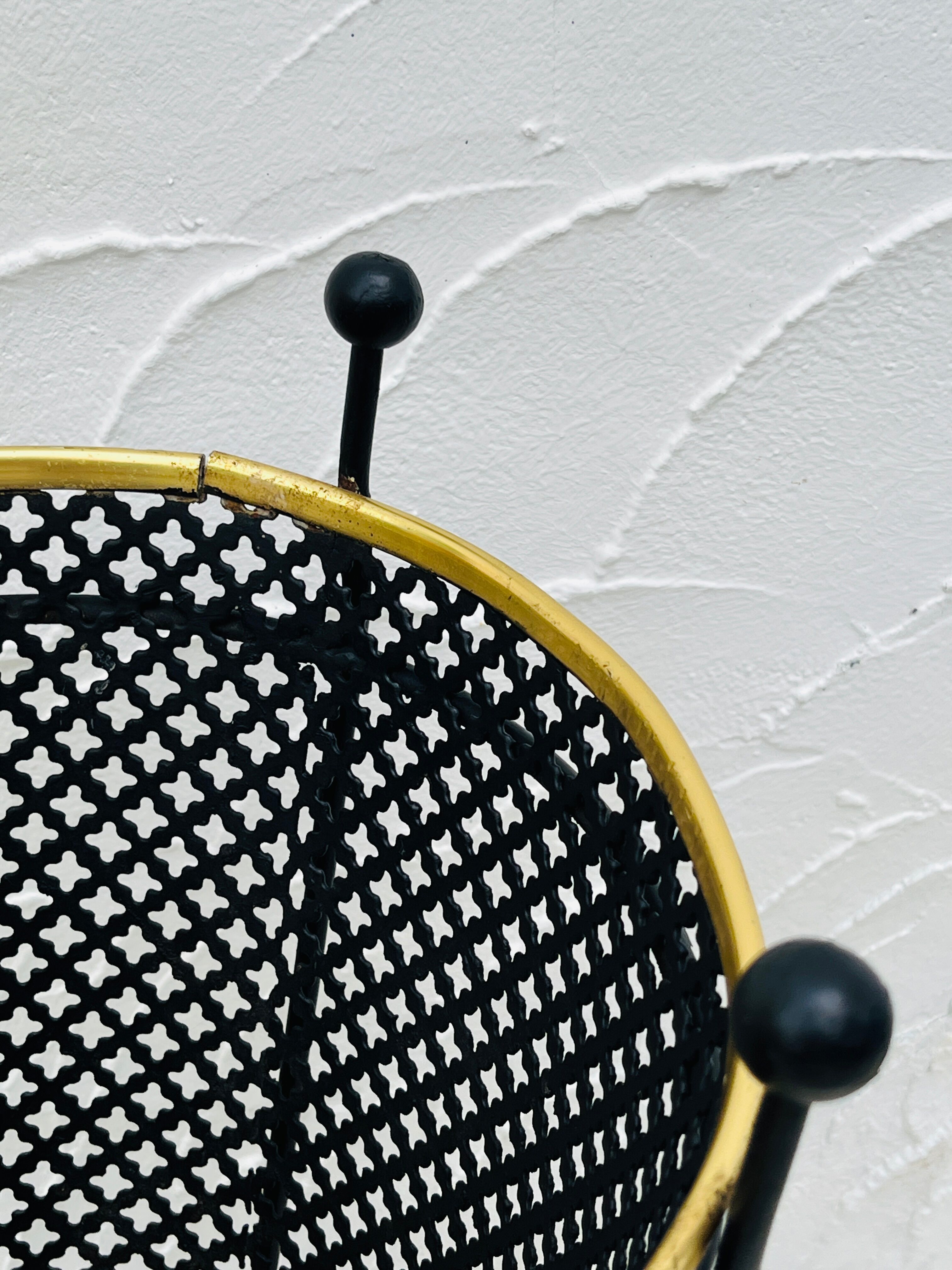 Vintage black perforated metal and brass umbrella stand