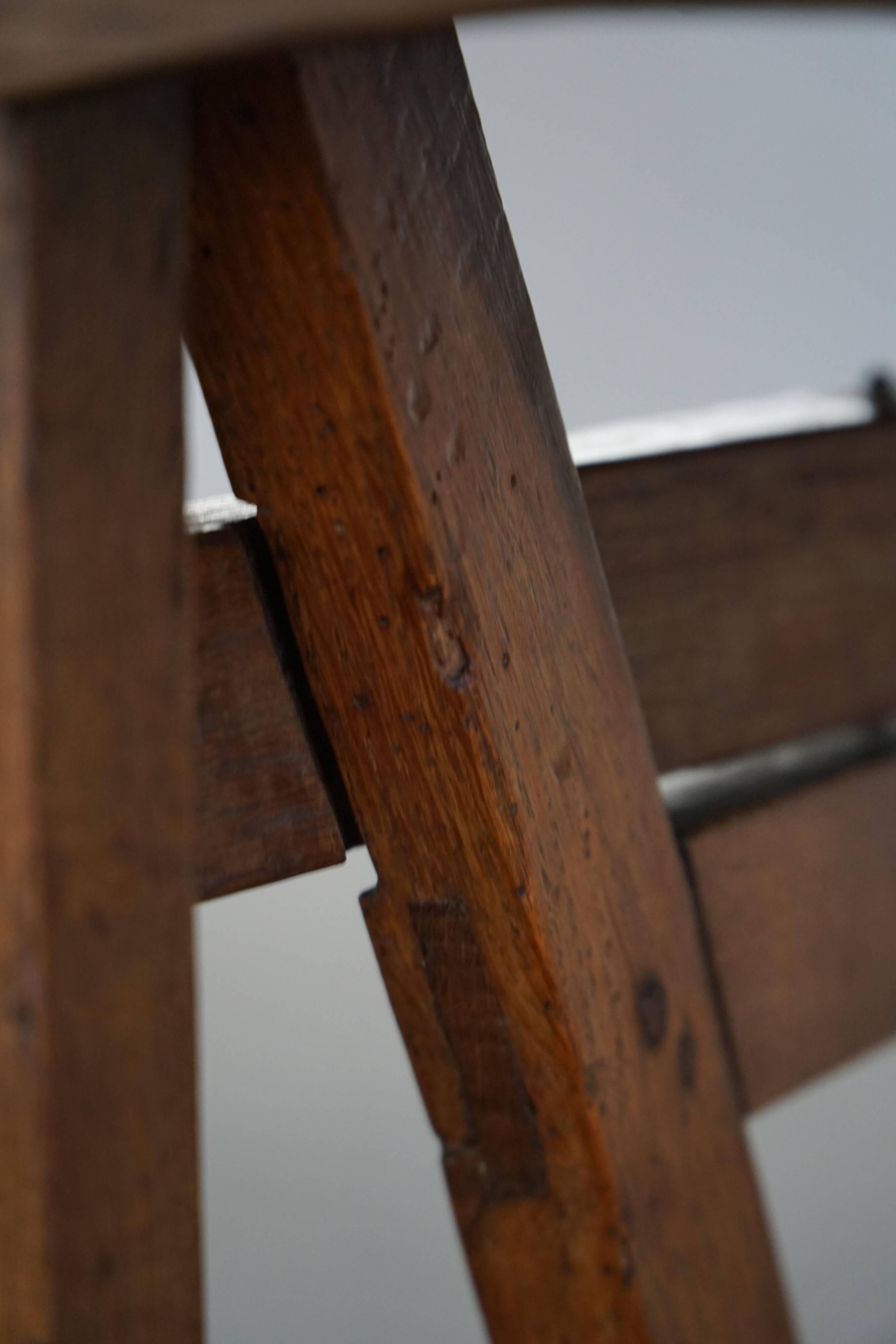 19th-century French round wine table with an adjustable top and floral textile surface.