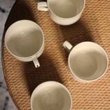 A set of 4 Sarreguemines ecru and gold earthenware cups