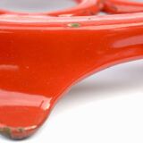 Vintage red enameled cast iron trivet