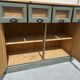 Antique counter cabinet with drawers and label holders – green patina