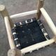 Traditional Moroccan stool in black leather and raw wood
