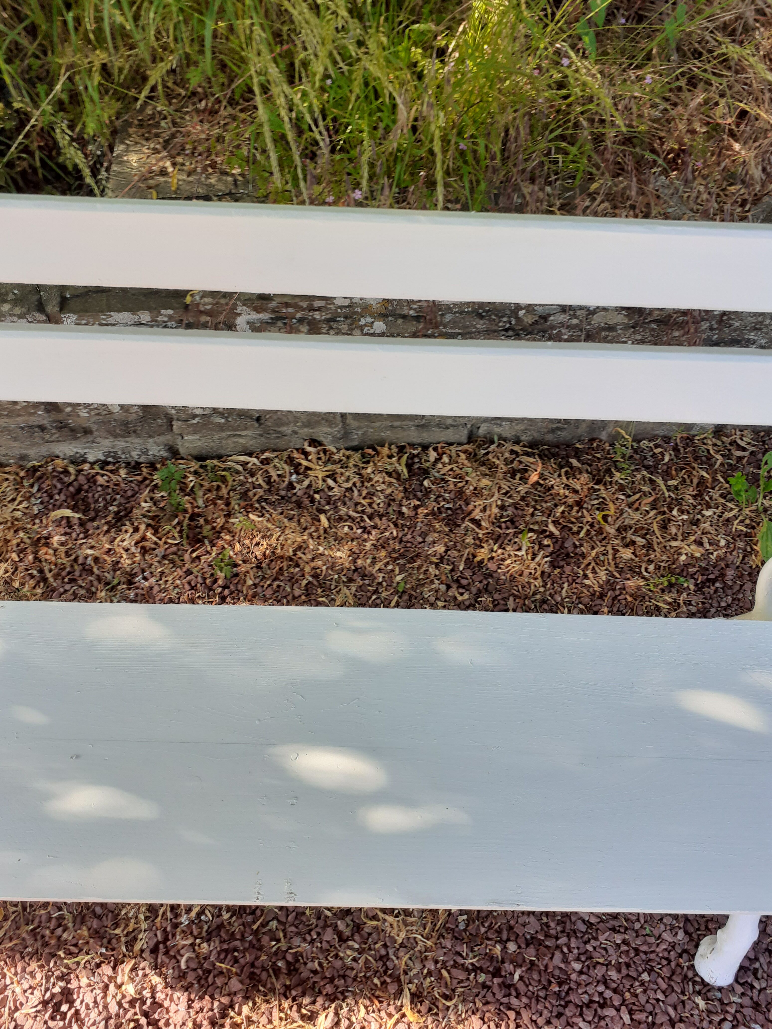 Old garden bench with cast iron feet and wooden planks