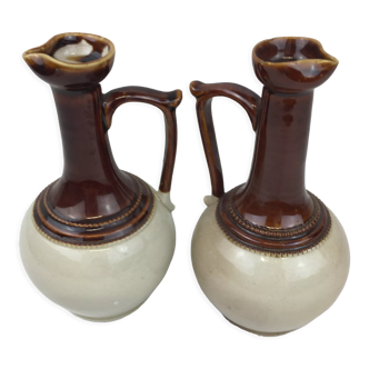 Old handmade pitchers in glazed terracotta in beige and brown color