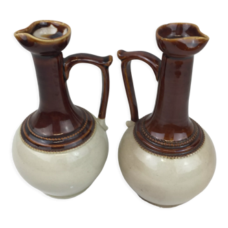Antique handmade pitchers in beige and brown enamelled terracotta