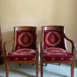 Paire de fauteuils Empire bordeaux à motif lyre , pieds sabre, accotoirs sculptés têtes de dauphin X
