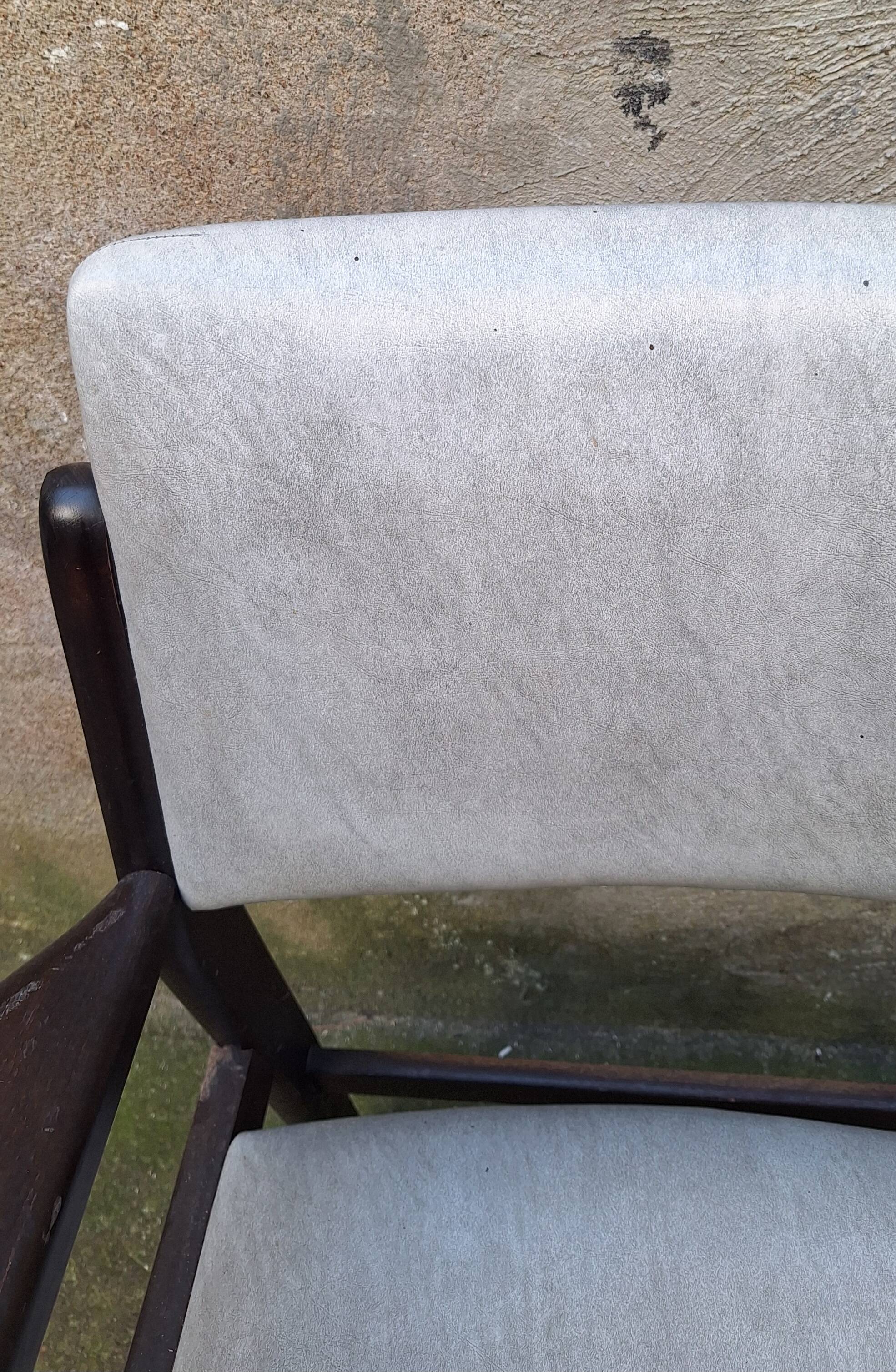 Wooden armchair and faux leather.