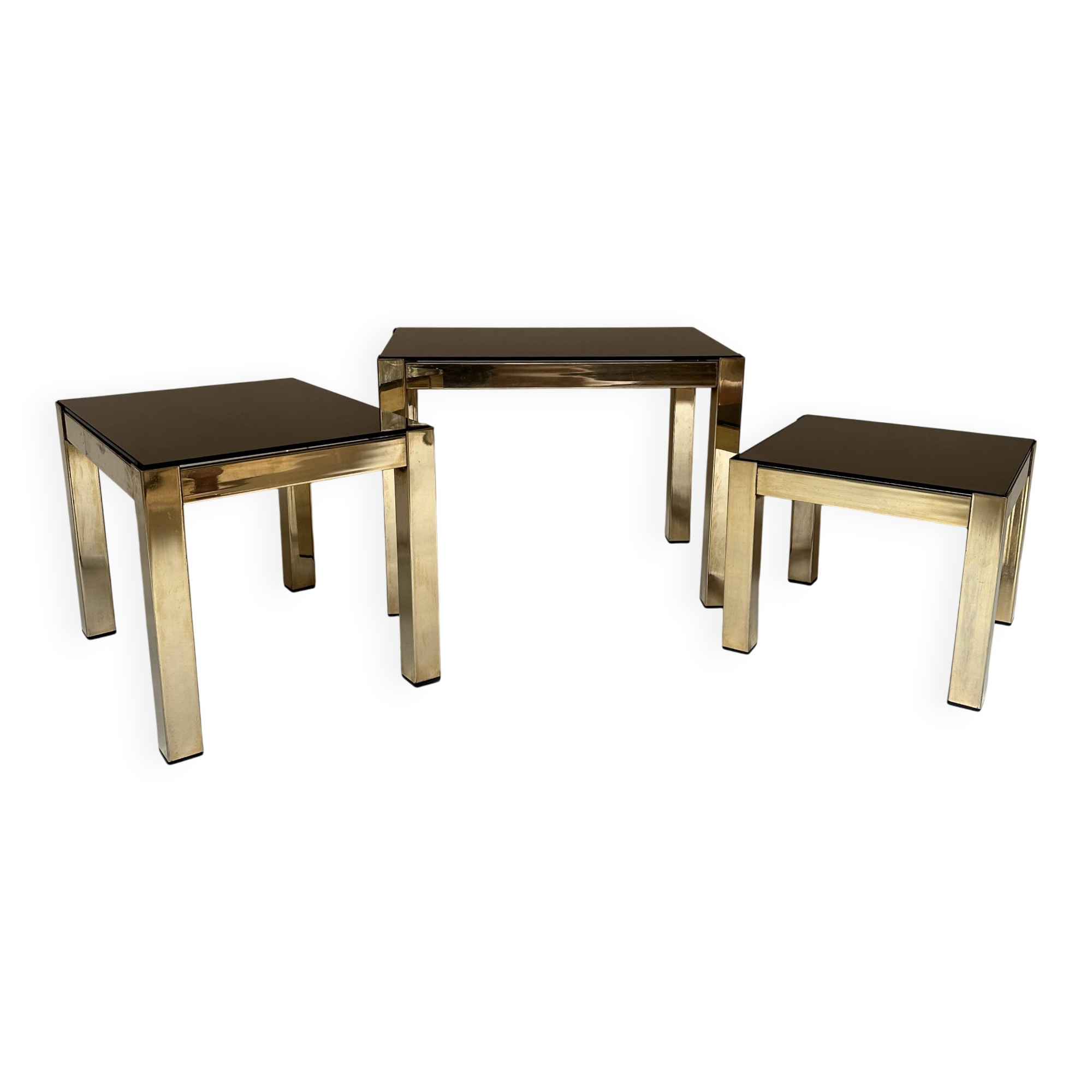 Set of three nesting side tables in brass and smoked mirror.