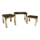Set of three nesting side tables in brass and smoked mirror.