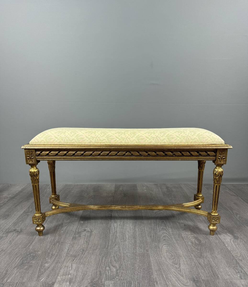 Antique gilded wooden bench in Louis XVI style, 19th century.