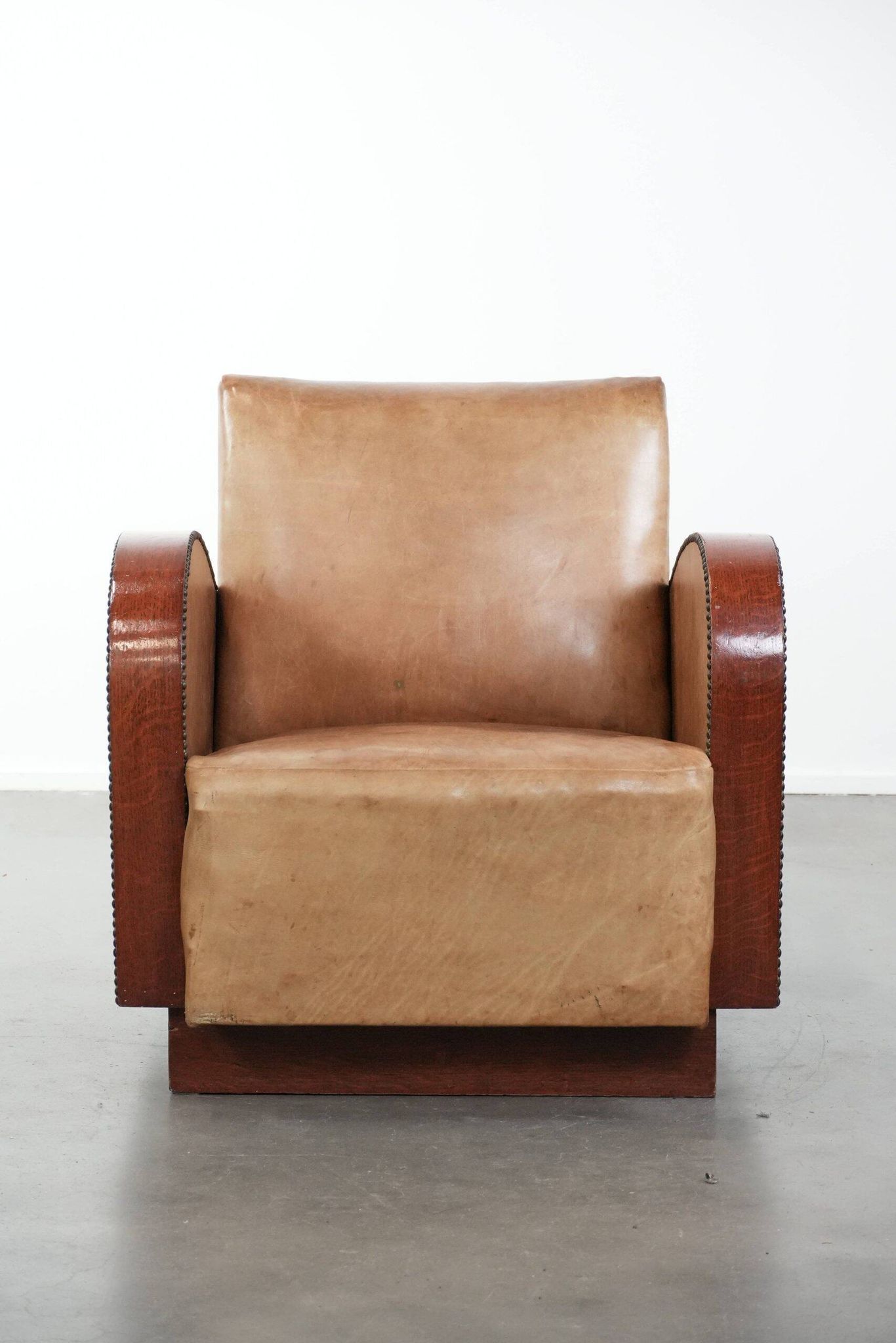 Art Deco design armchair in light cognac cowhide leather.