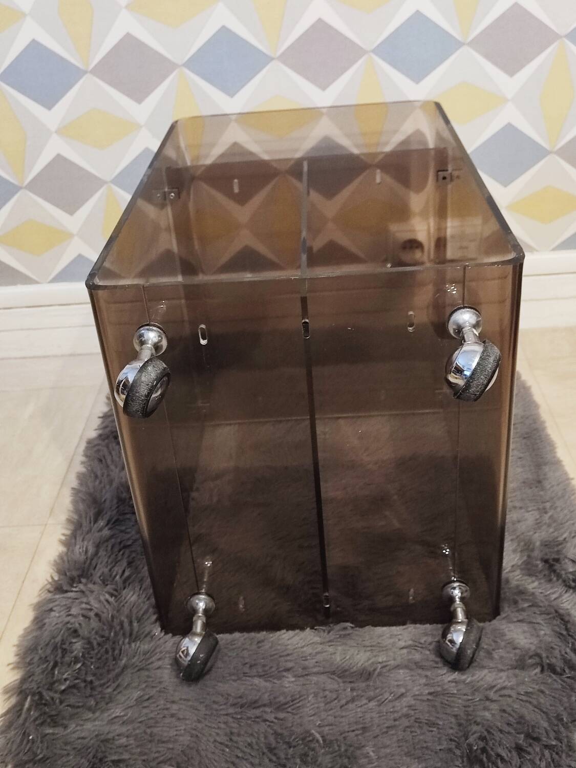 Michel Dumas smoked Plexiglas rolling table.